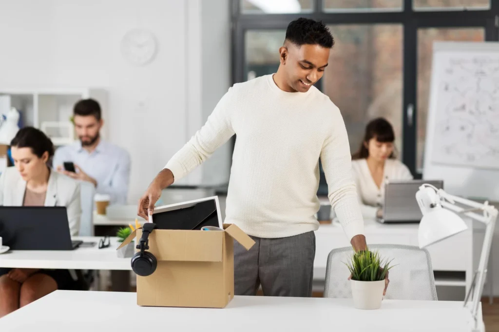 happy male office worker with personal stuff